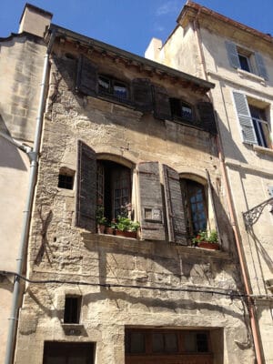 Pretty balcony with shutters in Arles