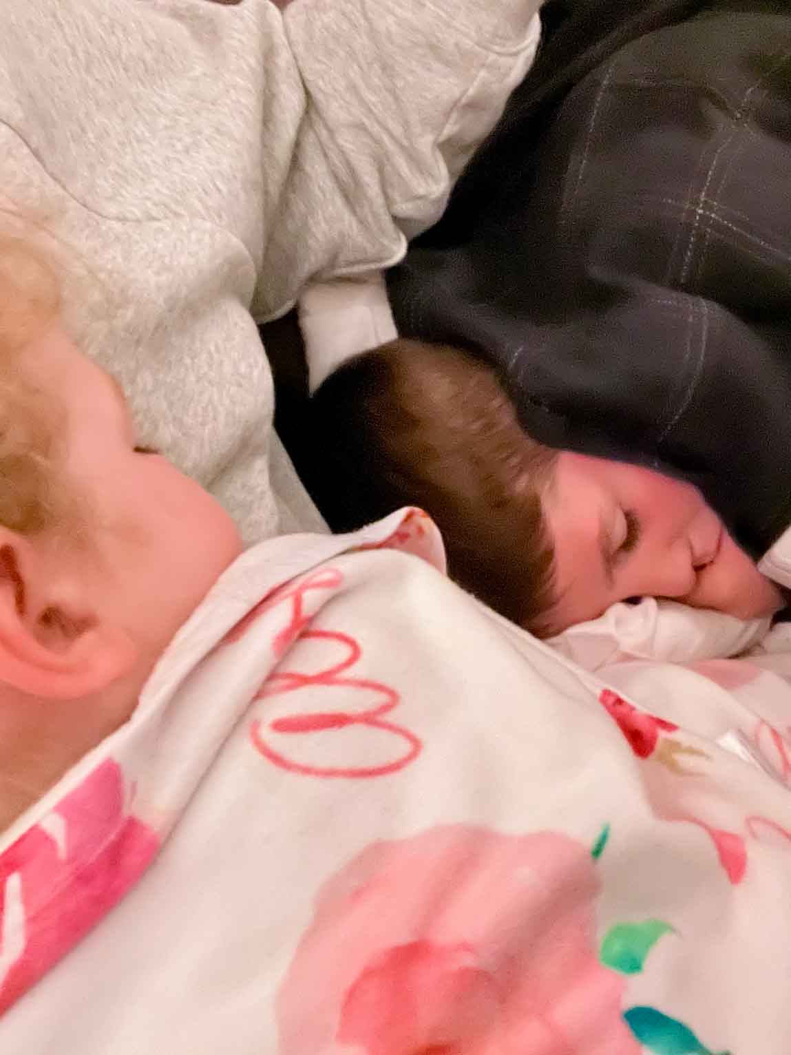 kids asleep on one another on the airplane