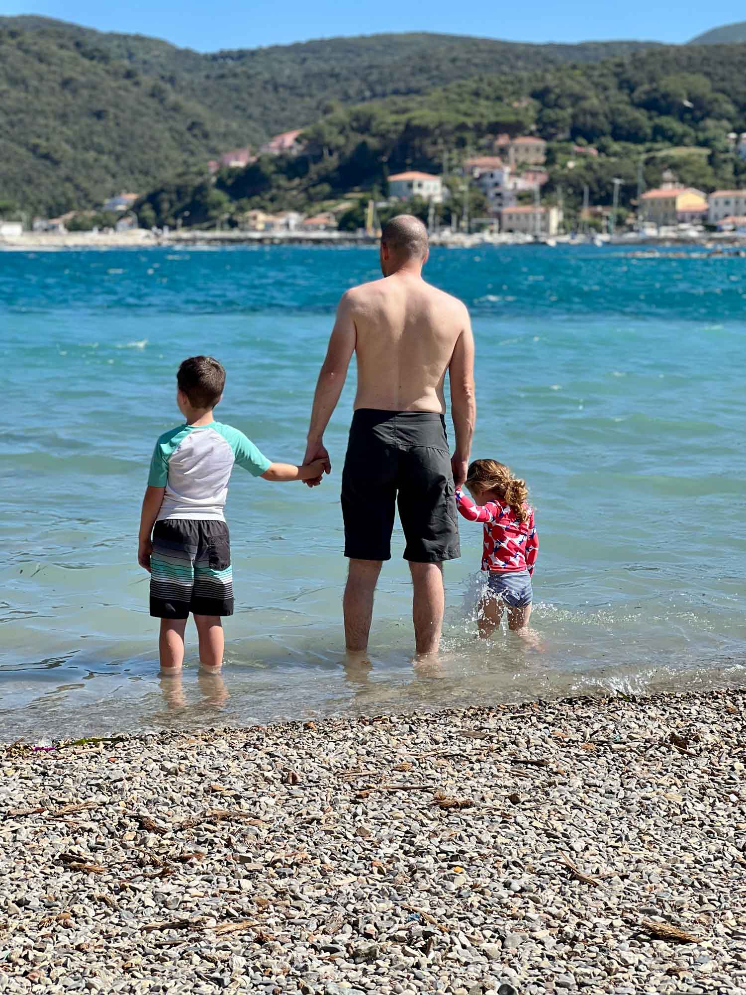 Dad and two kids playing in the Mediterranean Sea