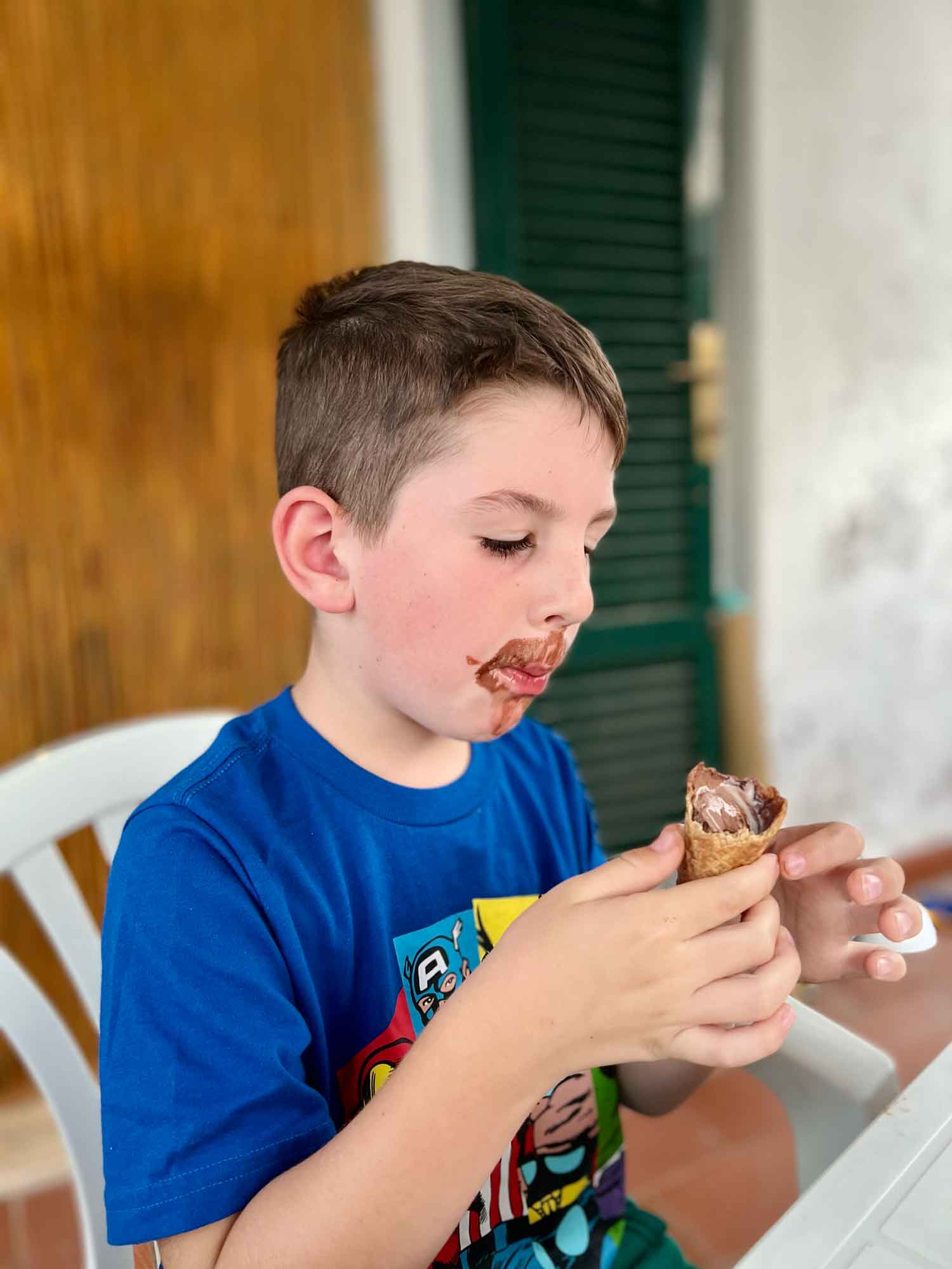little boy finishes an ice cream cone