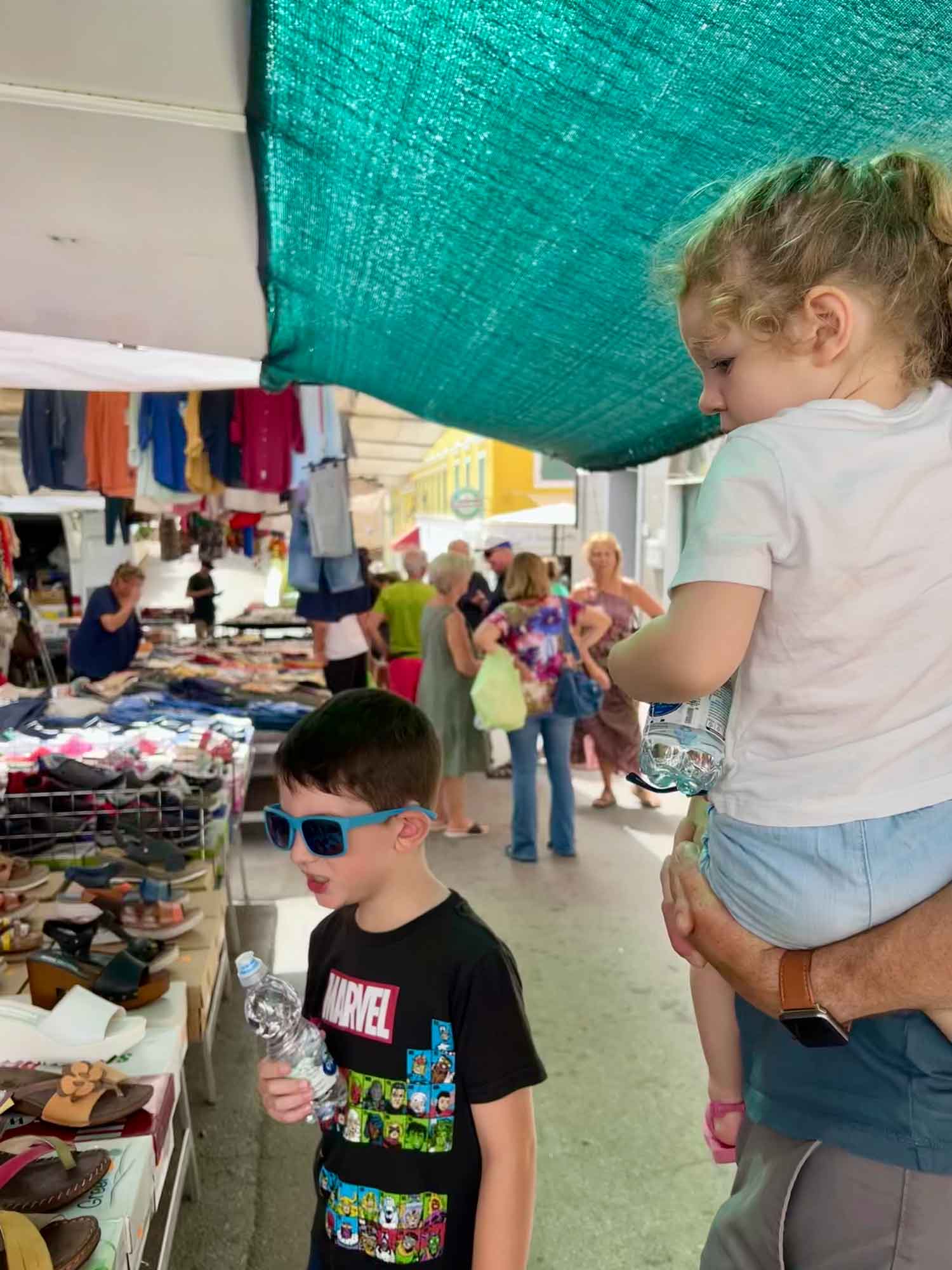 family looking at items at a market