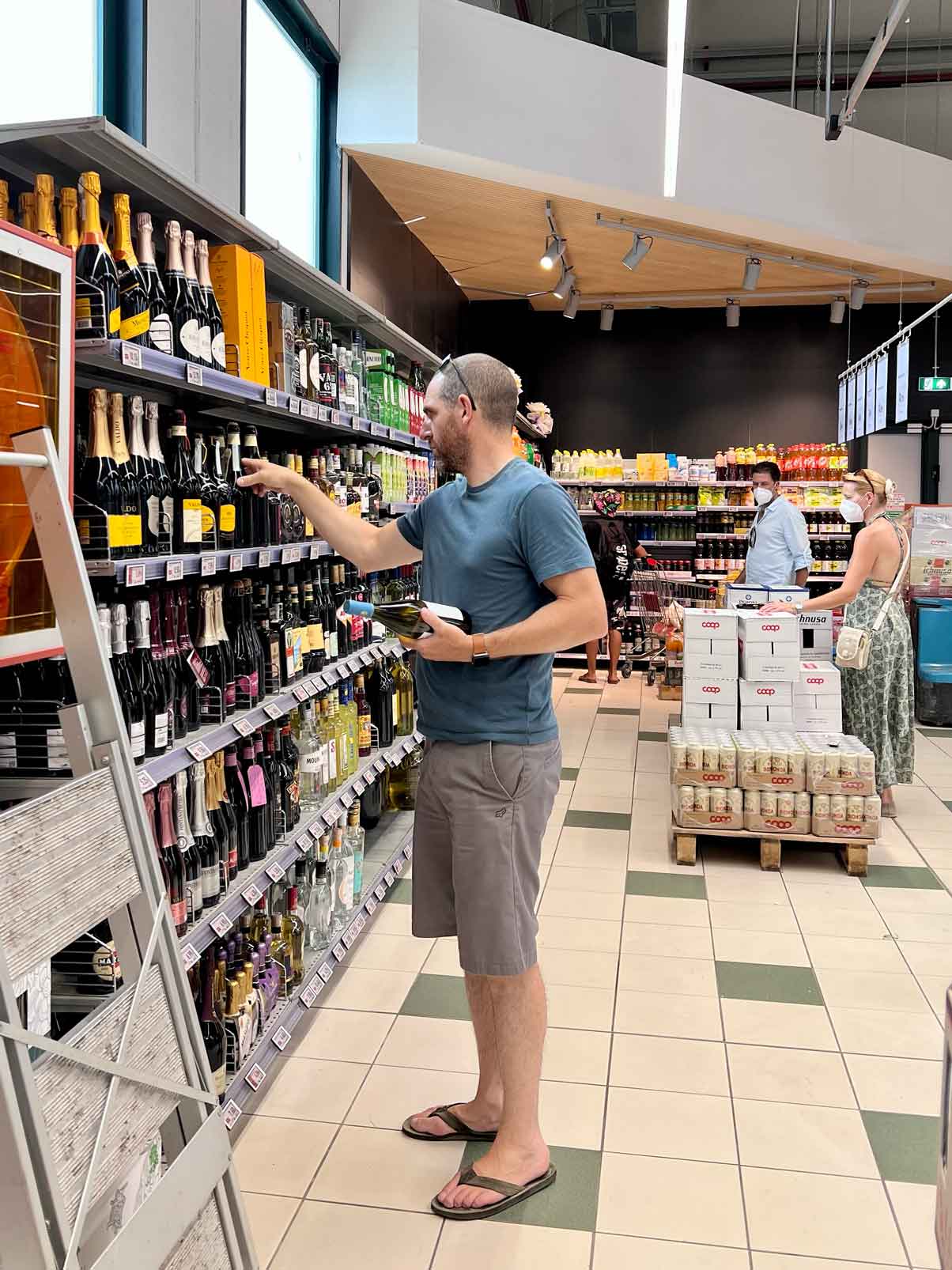 Man looking at wine selection at grocery store