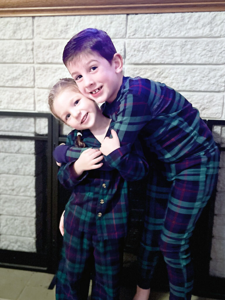 two kids in Christmas pajamas