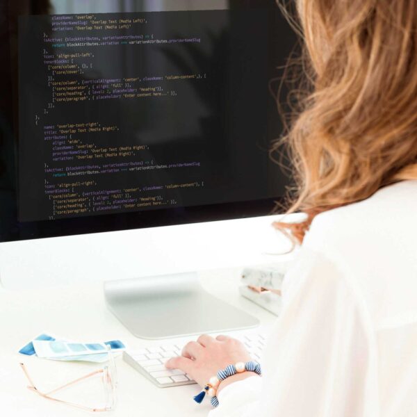 over the shoulder view of a young woman coding